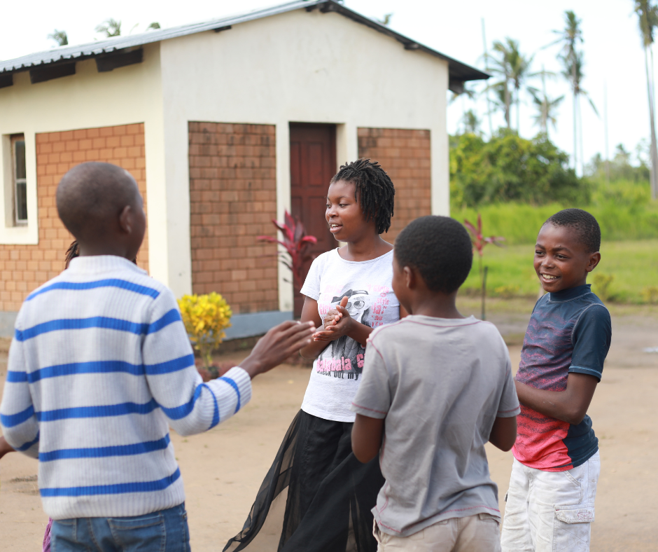Esperanca with her family and peers